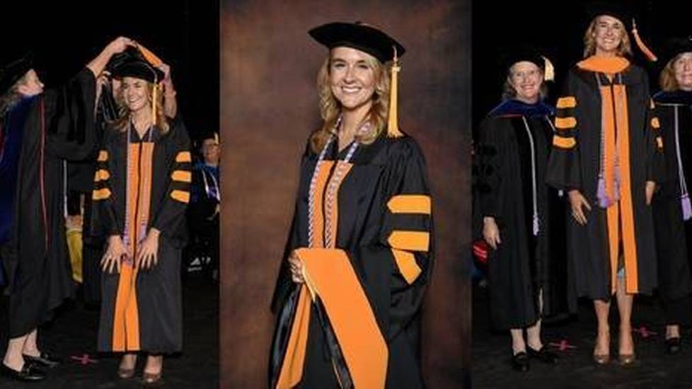 Nurse earning PhD and wearing robes