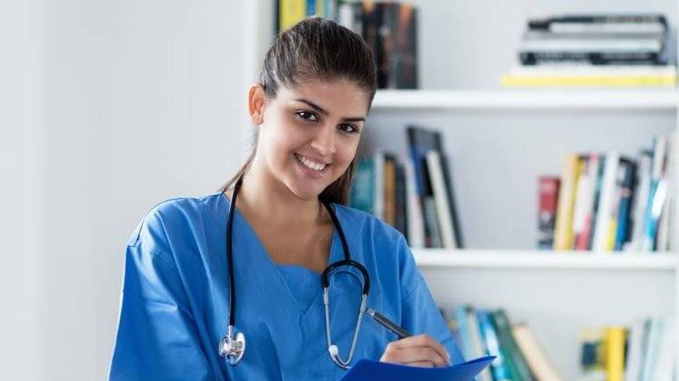Nurse student taking notes in library
