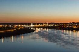 River in Montana at dusk with city in background