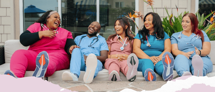 Nurses in scrubs sitting together with The Nursing Beat and Nurse.org logos representing their partnership.